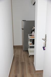 a kitchen with a refrigerator and a wooden floor at Maison d'hote villa monique in Cuges-les-Pins +3 photos