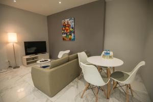 a living room with a couch and a table at 85 SOHO Premium Residences in Yangon