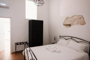 a bedroom with a bed with two towels on it at Borgo Sant' Angelo Exclusive House in Conversano