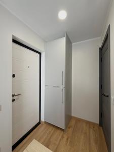 an empty closet with white walls and a door at DEUX rooms in Liepāja +8 photos