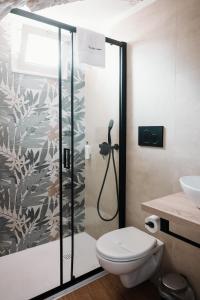 a bathroom with a shower with a toilet and a sink at Borgo Sant' Angelo Exclusive House in Conversano +19 photos