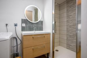 a bathroom with a sink and a mirror at Le 38-Appart'Hôtel-GregIMMO in Montbéliard +37 photos
