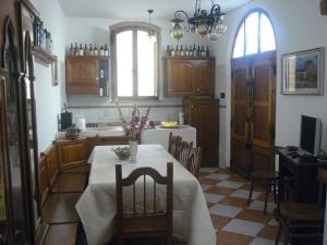 a kitchen with a table with a vase of flowers on it at Il Pozzo Della Citerna in Castelnuovo Berardenga
