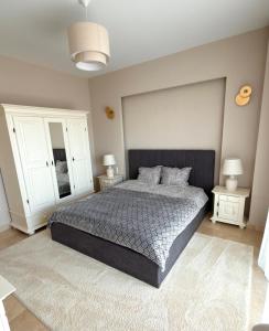 a bedroom with a large bed and two night stands at Sophia Luxury Residence in Mamaia