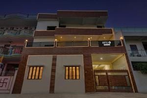 a building with a sign on the front of it at Super Hotel O Sudhirpur near Phonix Hospital in Varanasi