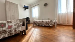a living room with a couch and a chair at Locanda dei Sapori in Marozzo