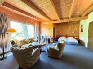 a living room with couches and a bed at RS Aparthotel in Schöppenstedt