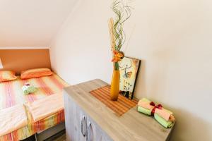 a bedroom with a bed and a vase on a table at Apartments Anastasija in Herceg-Novi