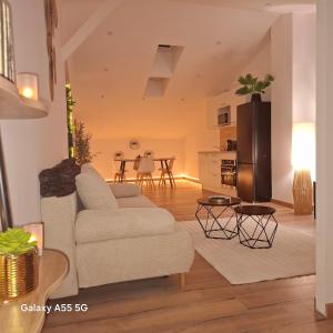 a living room with a white couch and a table at Suite Canopée & Spa in Albi