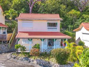 a small house with a red roof at LA CAZ'ANOLI in Sainte-Anne