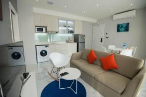a living room with a couch and a kitchen at 85 SOHO Premium Residences in Yangon