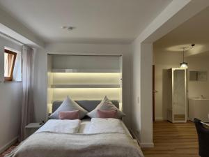 a bedroom with a large bed with two pillows at Ferienwohnungen Auszeit Taubertal in Bad Mergentheim