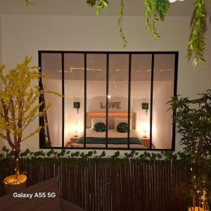 a large mirror reflecting a bedroom in a room at Suite Canopée & Spa in Albi