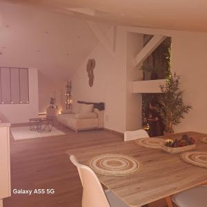 a living room with a table and a couch at Suite Canopée & Spa in Albi