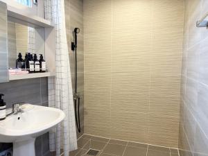 a bathroom with a shower and a sink at 깨비하우스202 in Wŏlsan