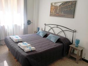 a bedroom with a large bed with towels on it at Cattaneo 19 Rooms in Verona
