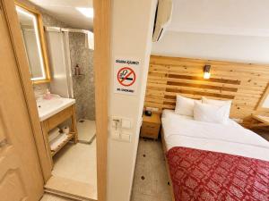 a small bathroom with a bed and a sink at Marmara Guesthouse in Istanbul +142 photos