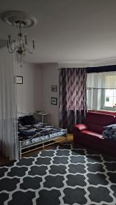 a bedroom with a couch and a bed and a rug at Blue House 2 in Warsaw