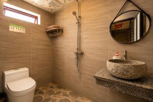 a bathroom with a sink and a toilet and a mirror at Mega View Homestay in Sapa +40 photos