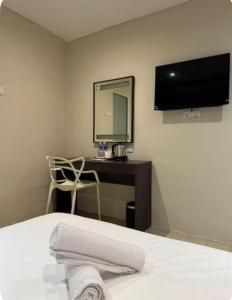 a bedroom with a bed and a desk with a mirror at Q Inn by Pillow Plus in Petaling Jaya +18 photos