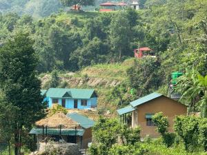 a group of houses on the side of a mountain at Tranquility Apartment in Pokhara