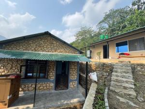 a house with a green awning in front of it at Tranquility Apartment in Pokhara