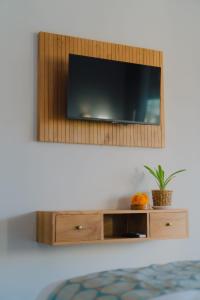 a flat screen tv hanging on a wall at Ardinia Villa Ubud Private Pool in Ubud