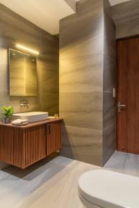 a bathroom with a tub and a toilet and a sink at The Royal Apartments Manor I Roof Top Restaurant I Self Cooking Available I Lift I 7o1827o7o3 in Kasauli +151 photos