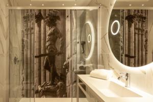 a bathroom with a shower with a statue in it at Hotel La Fortezza in Florence +44 photos