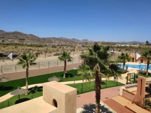 a view of a resort with palm trees and a pool at Playa y Geoda, escapada perfecta in Pilar de Jaravía +5 photos