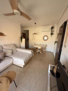 a living room with a couch and a table at Playa y Geoda, escapada perfecta in Pilar de Jaravía