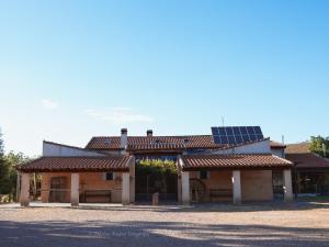 a house with solar panels on top of it at Las Lucías, experiencias de ecoturismo in Navatrasierra