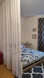 a bedroom with a bed with white curtains at Blue House 2 in Warsaw +12 photos