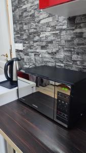 a microwave sitting on top of a kitchen counter at Blue House 2 in Warsaw
