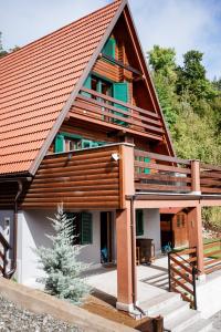 a house with an orange roof at Planinska kuća Vista in Mrkopalj