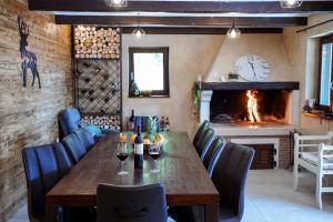 a dining room with a table and a fireplace at Planinska kuća Vista in Mrkopalj
