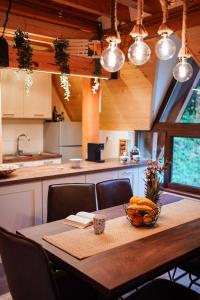 a kitchen with a table with a bowl of fruit on it at Planinska kuća Vista in Mrkopalj