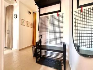 a dressing room with a bench and a mirror at Casa Viola in Balatonfüred
