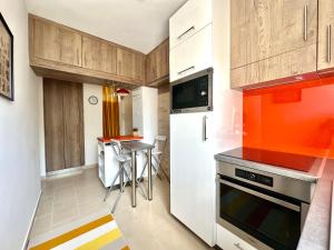 a kitchen with a white refrigerator and a table at Casa Viola in Balatonfüred