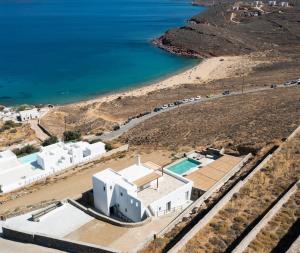 an aerial view of a white building and a beach at Villa Sozon Mykonos in Agios Sostis Mykonos