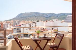 a table and chairs on a balcony with a view at Hostal Comercio in Denia