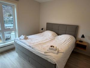 a bedroom with a bed with two stuffed animals on it at Geirangerbooking in Geiranger
