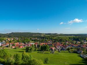 a small town in a green field with houses at Ferien Hotel Rennsteigblick in Friedrichroda