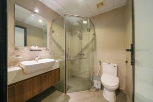 a bathroom with a sink and a toilet and a shower at Modapick Bạch Đằng - Living in the nature garden with full river view in Hanoi +44 photos