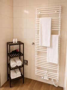 a towel rack in a bathroom with towels at Gästehaus Munk in Günzburg +31 photos
