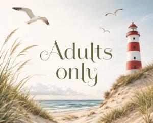 a lighthouse on a beach with the words adults only at De Zilte Zeehoeve in Ellemeet