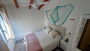 a bedroom with a bed with a net on the wall at Paradise COSTA ARENAL in Es Mercadal +37 photos
