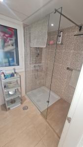a shower with a glass door in a bathroom at 240 Front line beach La Cala in La Cala de Mijas +9 photos
