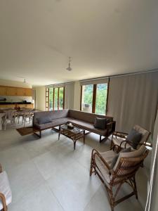 a living room with a large couch and chairs at Riverside Jahliye, Chouf in Al Jāhilīyah