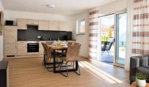 a kitchen and dining room with a table and chairs at Gästehaus Munk in Günzburg